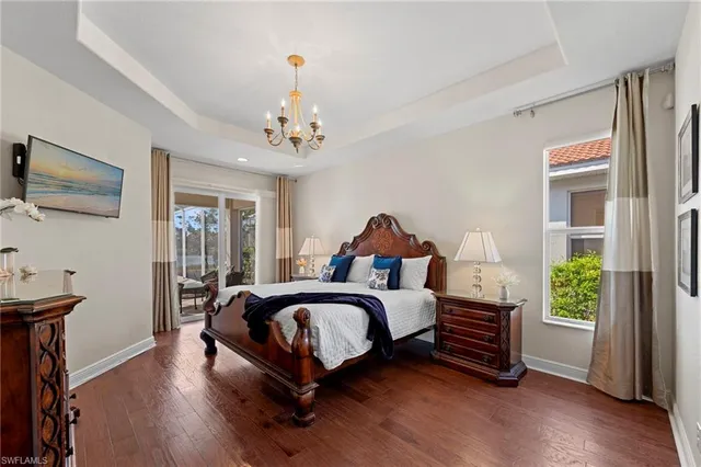 a view of a swimming pool with a table and chairs under an umbrella