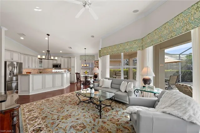 a living room with furniture and a kitchen view