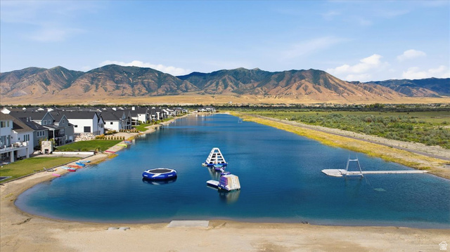 21 Pier Place Tooele, UT 84074 - Photo 104 of 112 Expansive lakefront setting featuring a sandy beach shoreline, mountains in the distance, and waterside residential properties