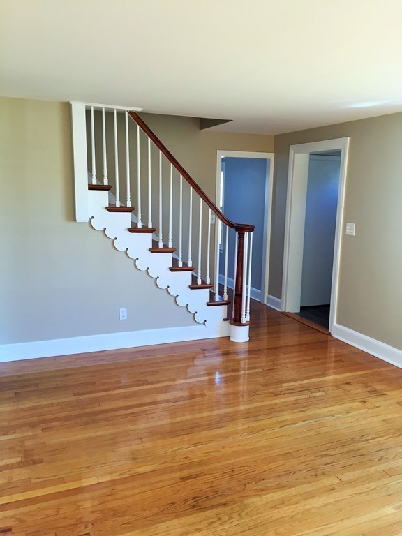 33 2nd Island Road Webster, MA 01570 - Photo 11 of 27 a view of empty room with wooden floor and fan