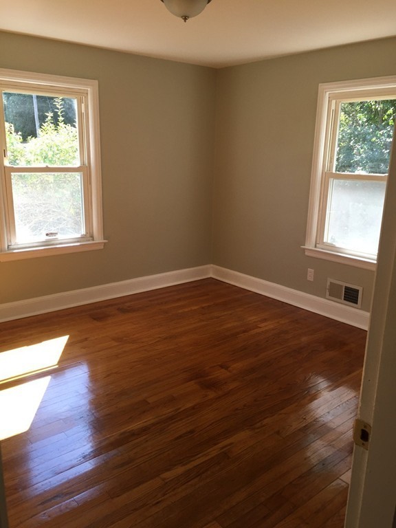 33 2nd Island Road Webster, MA 01570 - Photo 6 of 27 a view of an empty room with wooden floor and a window