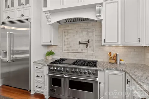 a kitchen with a sink stove and cabinets