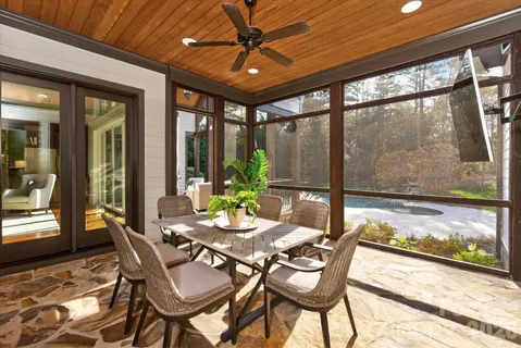 a view of house with garden and tall trees