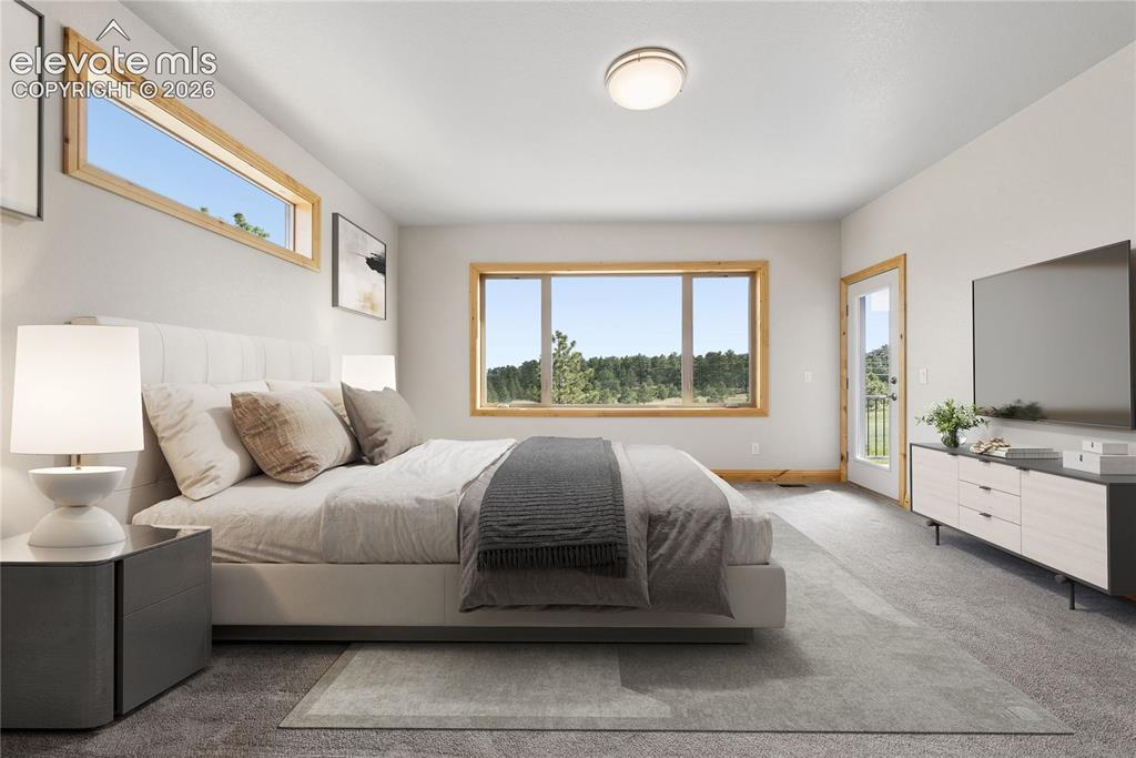 10840 Vollmer Road Colorado Springs, CO 80908 - Photo 24 of 49 a spacious bedroom with a bed and a large window