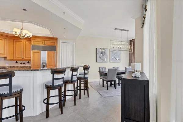 a large kitchen with stainless steel appliances granite countertop a stove refrigerator and cabinets