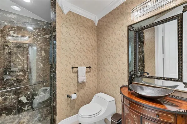 a view of a dining room with furniture a chandelier and wooden floor