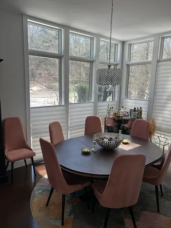 a dining room with furniture and window
