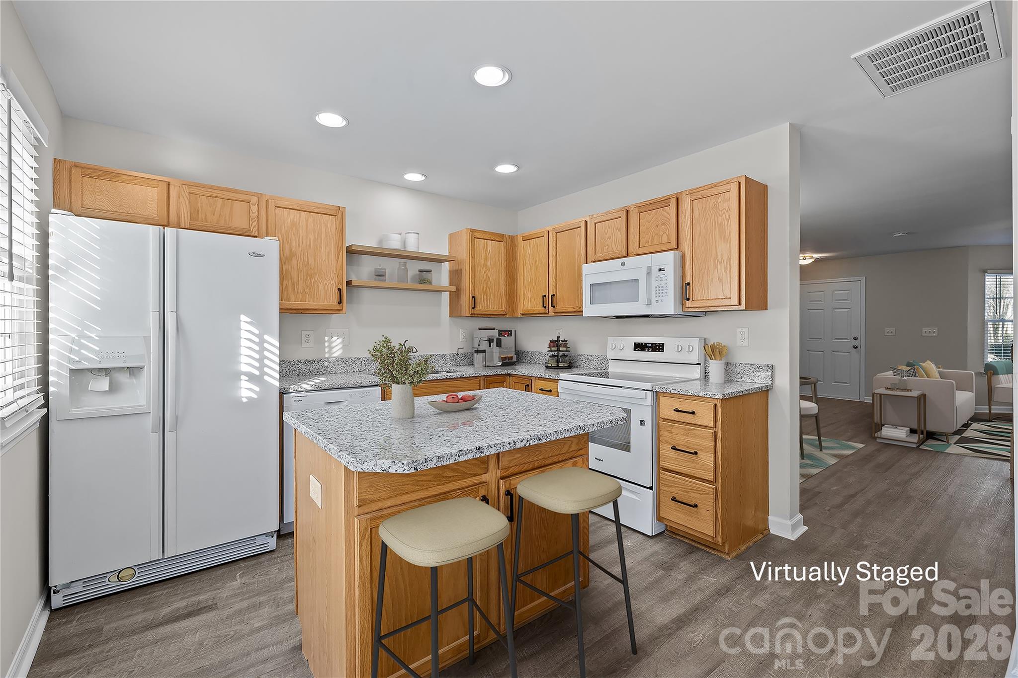 209 Primrose Walk Fort Mill, SC 29715 - Photo 14 of 39 a kitchen with refrigerator cabinets and wooden floor