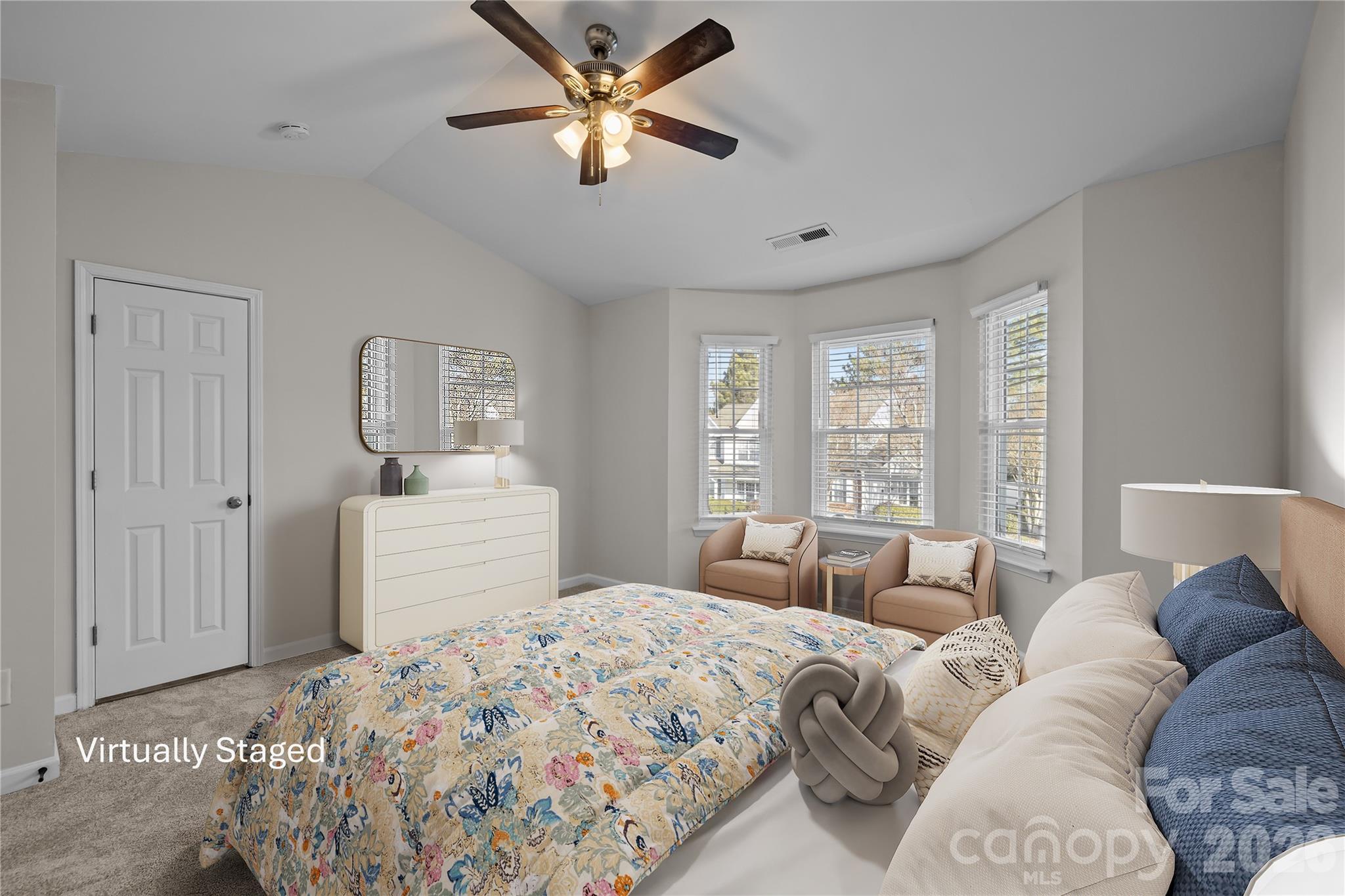 209 Primrose Walk Fort Mill, SC 29715 - Photo 20 of 39 a bedroom with a large bed and a chandelier