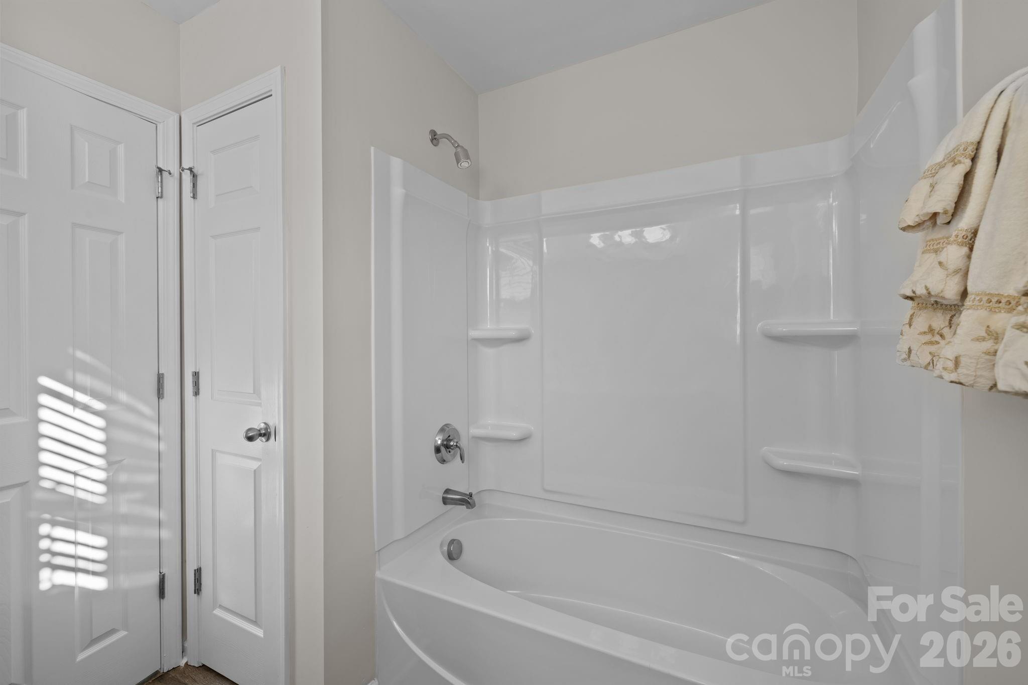 209 Primrose Walk Fort Mill, SC 29715 - Photo 28 of 39 a white bath tub sitting next to a shower