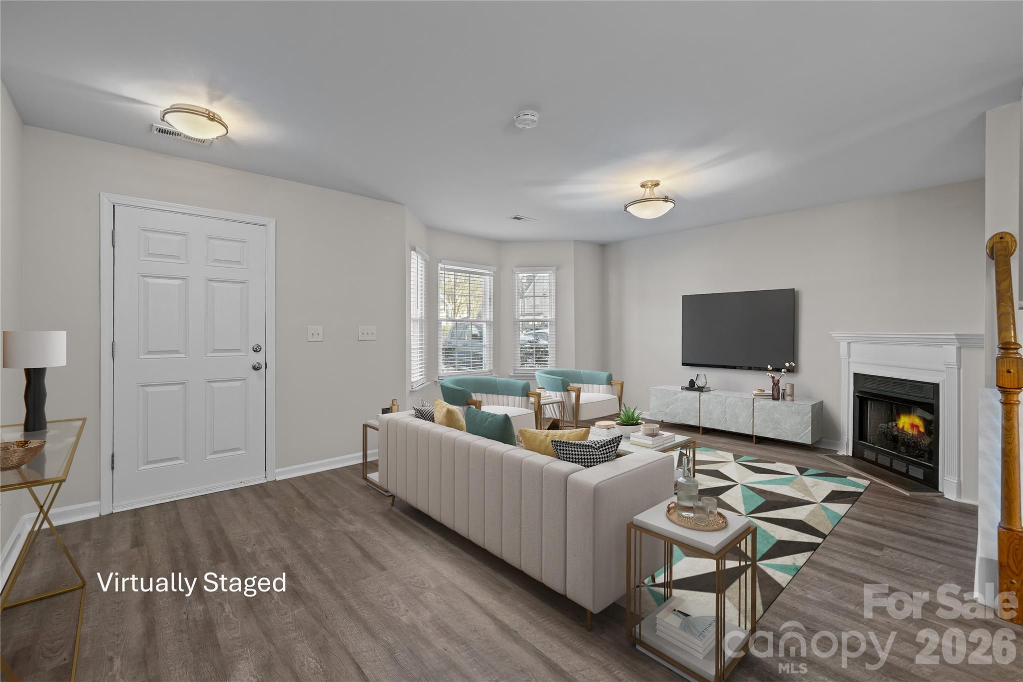 209 Primrose Walk Fort Mill, SC 29715 - Photo 4 of 39 a living room with furniture a fireplace and a flat screen tv