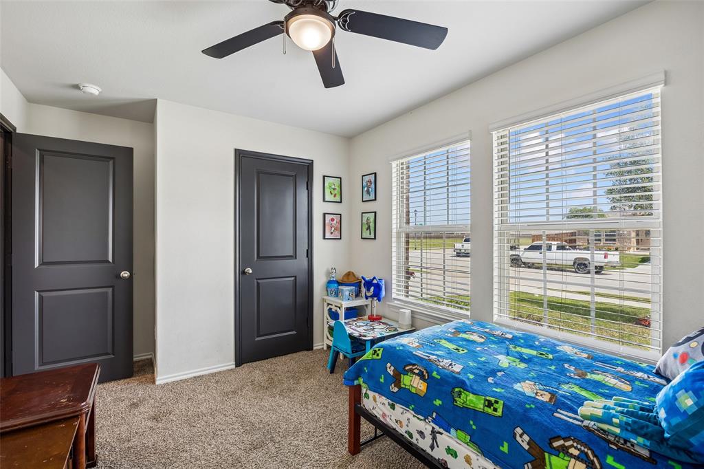 802 Rustic Way Royse City, TX 75189 - Photo 34 of 38 a bedroom with a bed and a chandelier