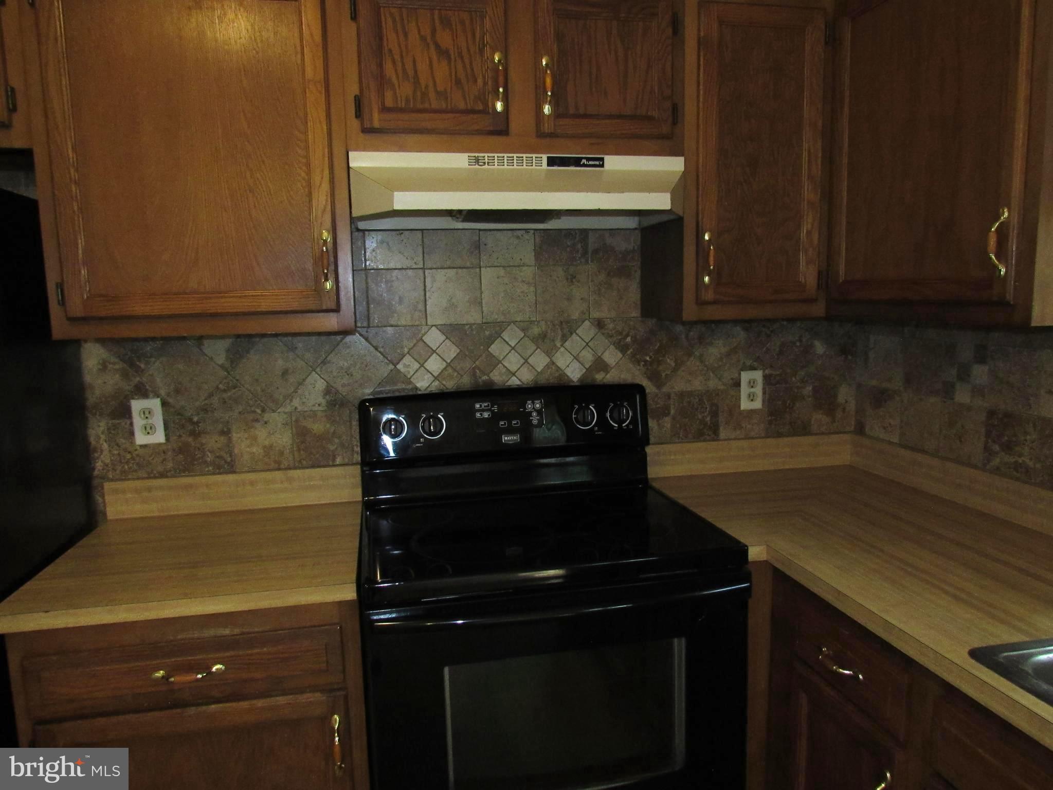 3235 Richfield Road Huntingtown, MD 20639 - Photo 28 of 64 a kitchen with a sink and cabinets