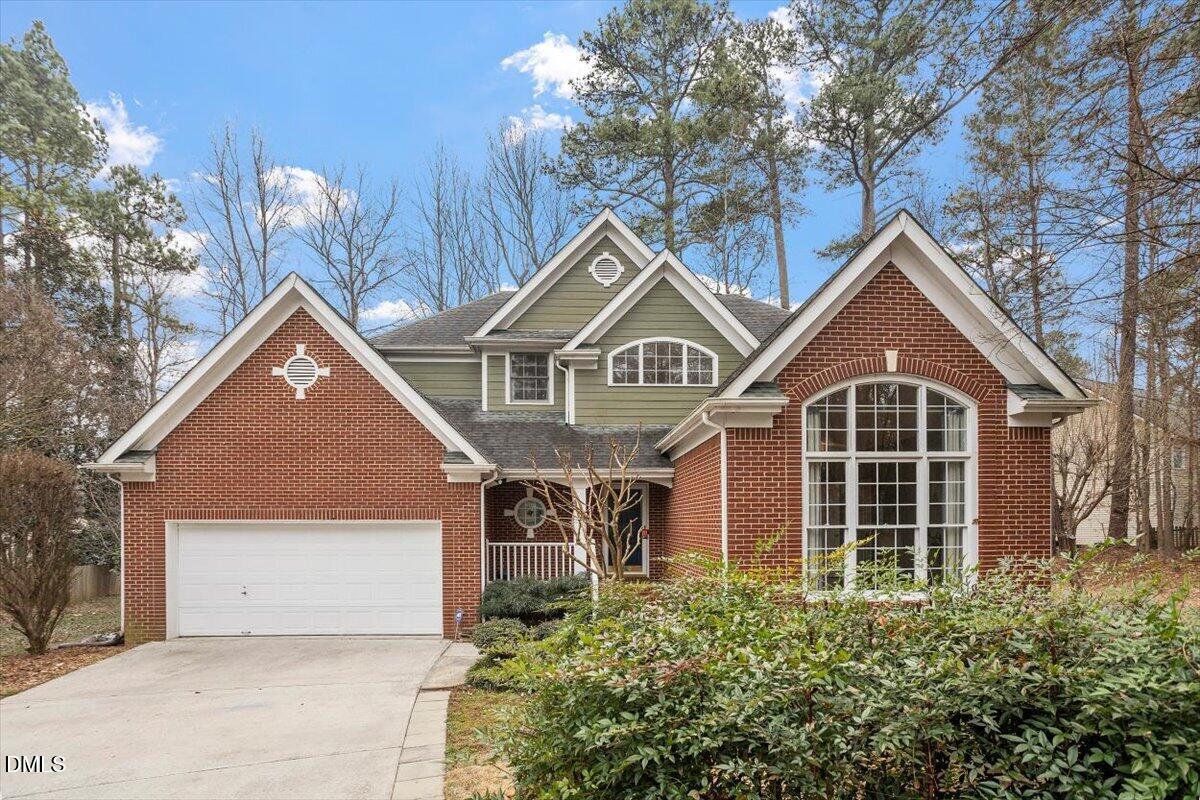 a front view of a house with yard and garage