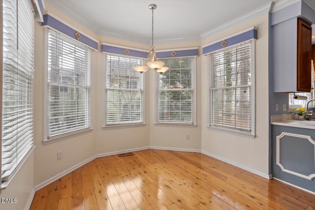 2804 Shofield Court Raleigh, NC 27615 - Photo 10 of 37 a view of an empty room with a window and wooden floor