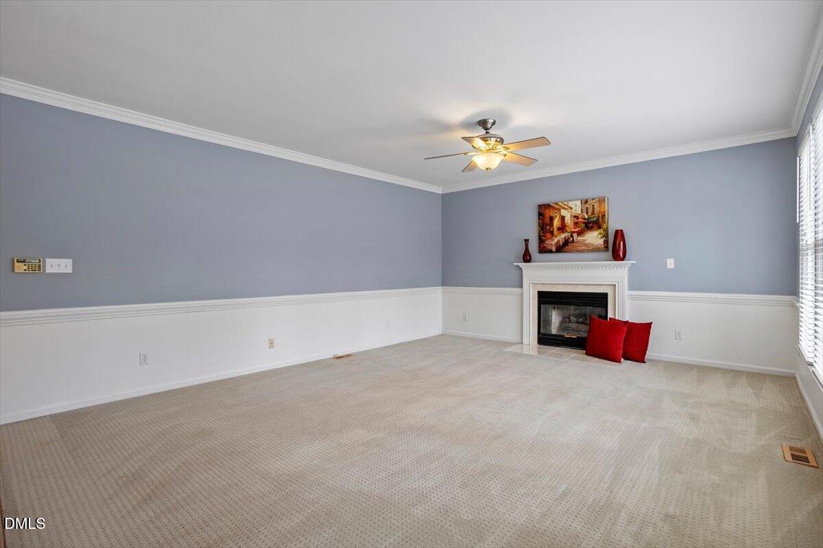 2804 Shofield Court Raleigh, NC 27615 - Photo 11 of 37 an empty room with furniture and a fireplace