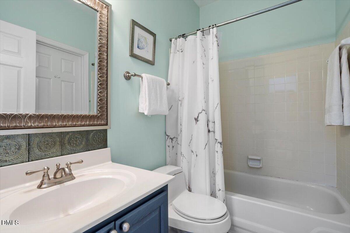 2804 Shofield Court Raleigh, NC 27615 - Photo 14 of 37 a bathroom with a sink a toilet and shower