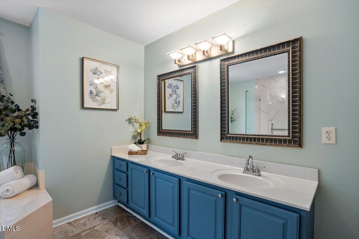 2804 Shofield Court Raleigh, NC 27615 - Photo 17 of 37 a bathroom with a toilet sink and mirror