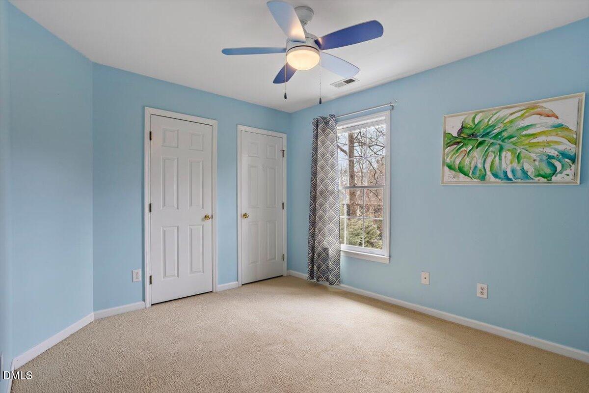 2804 Shofield Court Raleigh, NC 27615 - Photo 20 of 37 an empty room with windows and ceiling fan