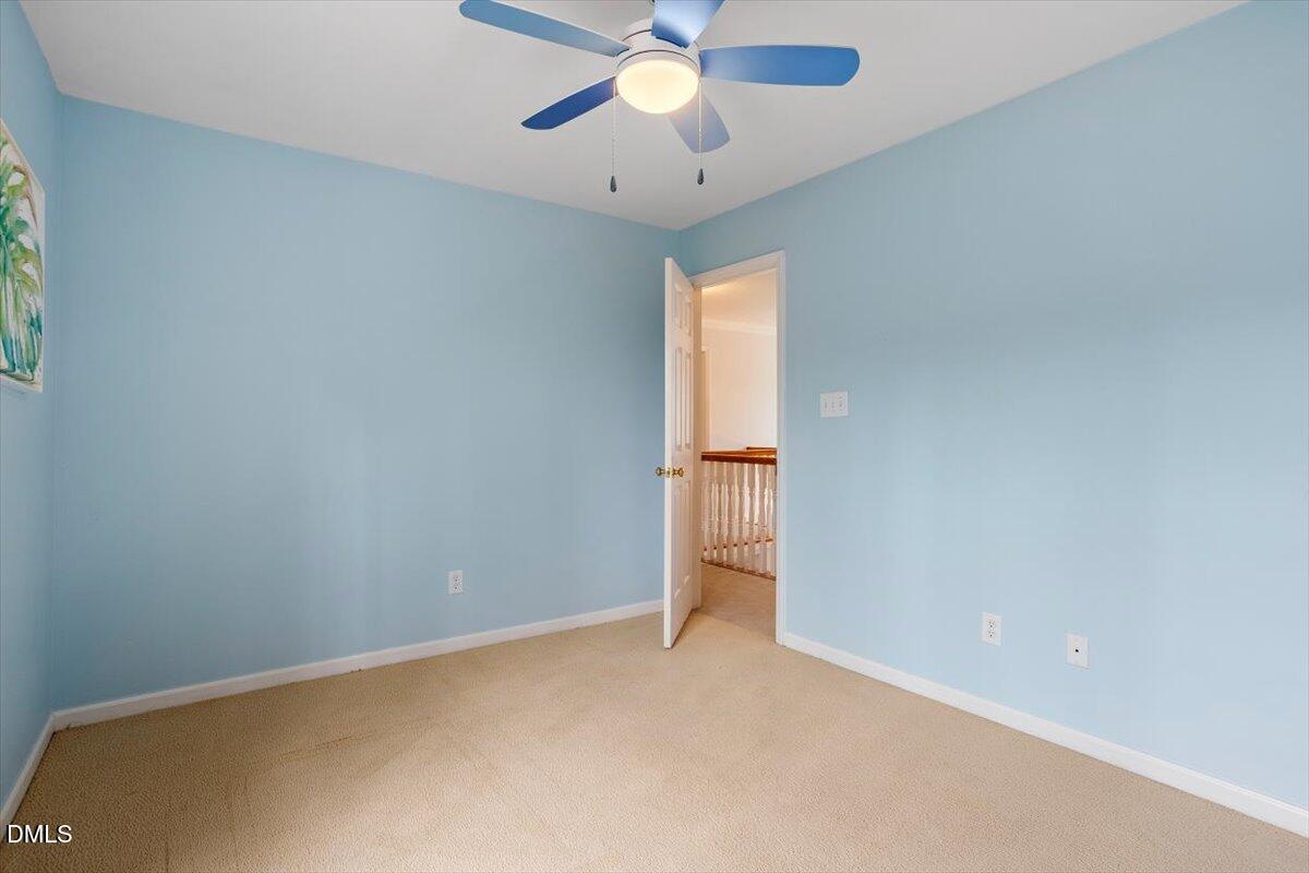 2804 Shofield Court Raleigh, NC 27615 - Photo 21 of 37 an empty room with closet and a chandelier fan