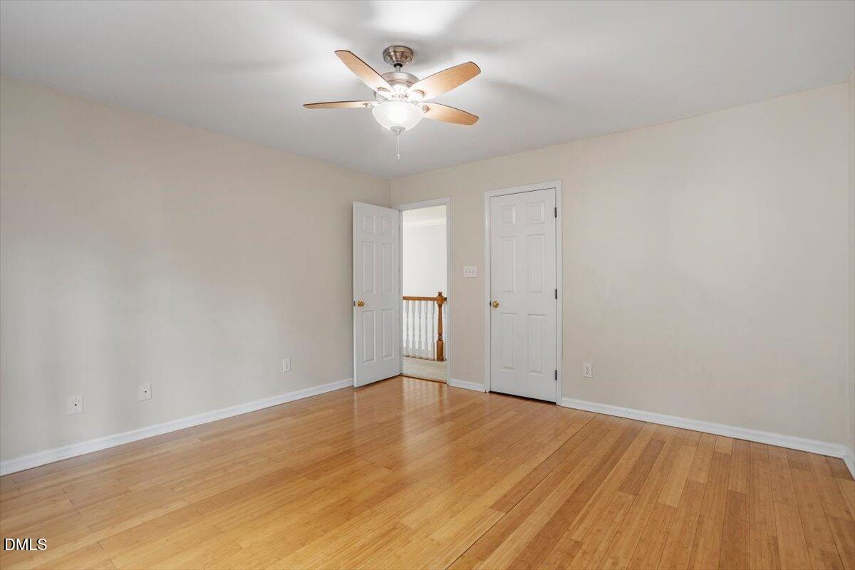 2804 Shofield Court Raleigh, NC 27615 - Photo 27 of 37 an empty room with wooden floor and ceiling fan