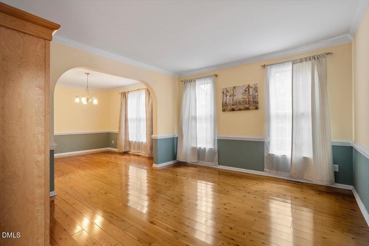 2804 Shofield Court Raleigh, NC 27615 - Photo 4 of 37 a view of an empty room with window and wooden floor