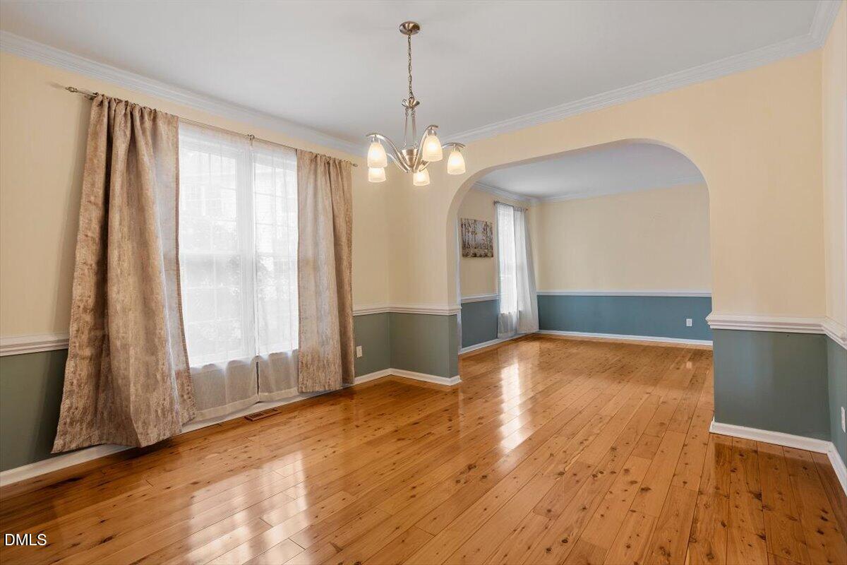 2804 Shofield Court Raleigh, NC 27615 - Photo 5 of 37 a view of an empty room with window and wooden floor