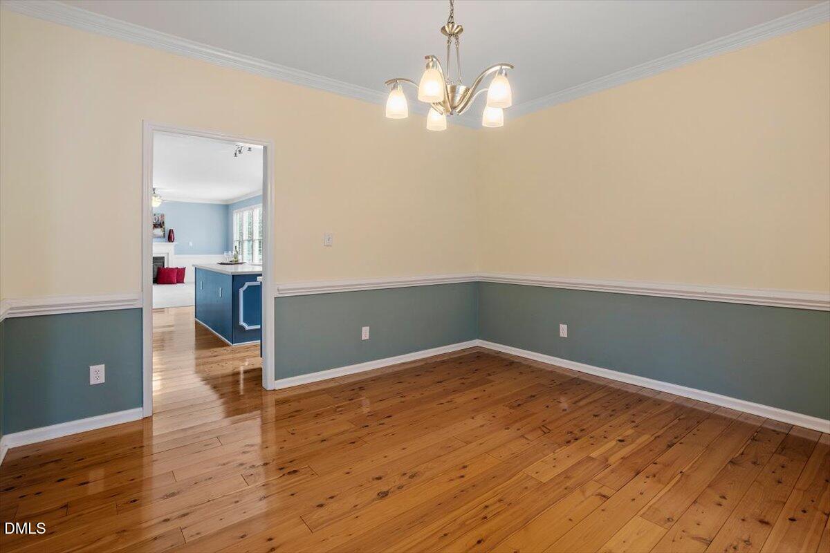2804 Shofield Court Raleigh, NC 27615 - Photo 6 of 37 a view of livingroom with hardwood floor and kitchen view