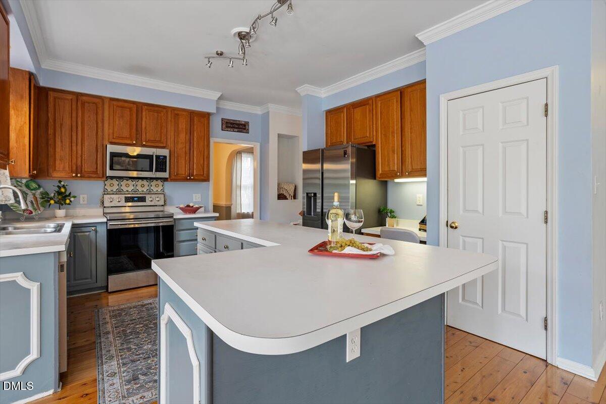 2804 Shofield Court Raleigh, NC 27615 - Photo 8 of 37 a kitchen with a sink a stove and chairs