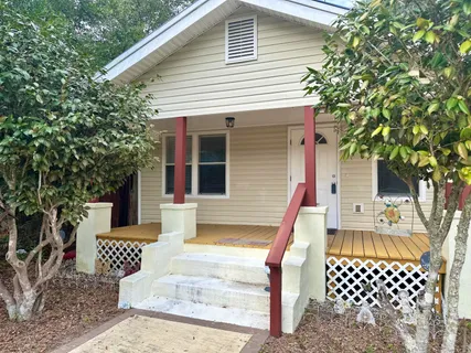 a view of balcony with wooden floor and garden