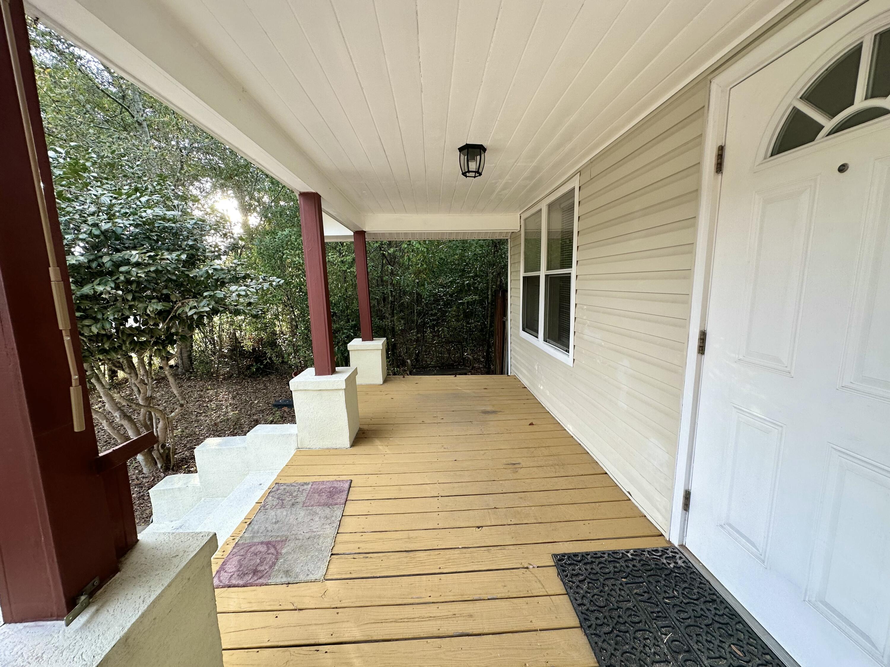 120 North Davis Lane DeFuniak Springs, FL 32433 - Photo 13 of 58 a view of balcony with wooden floor and garden