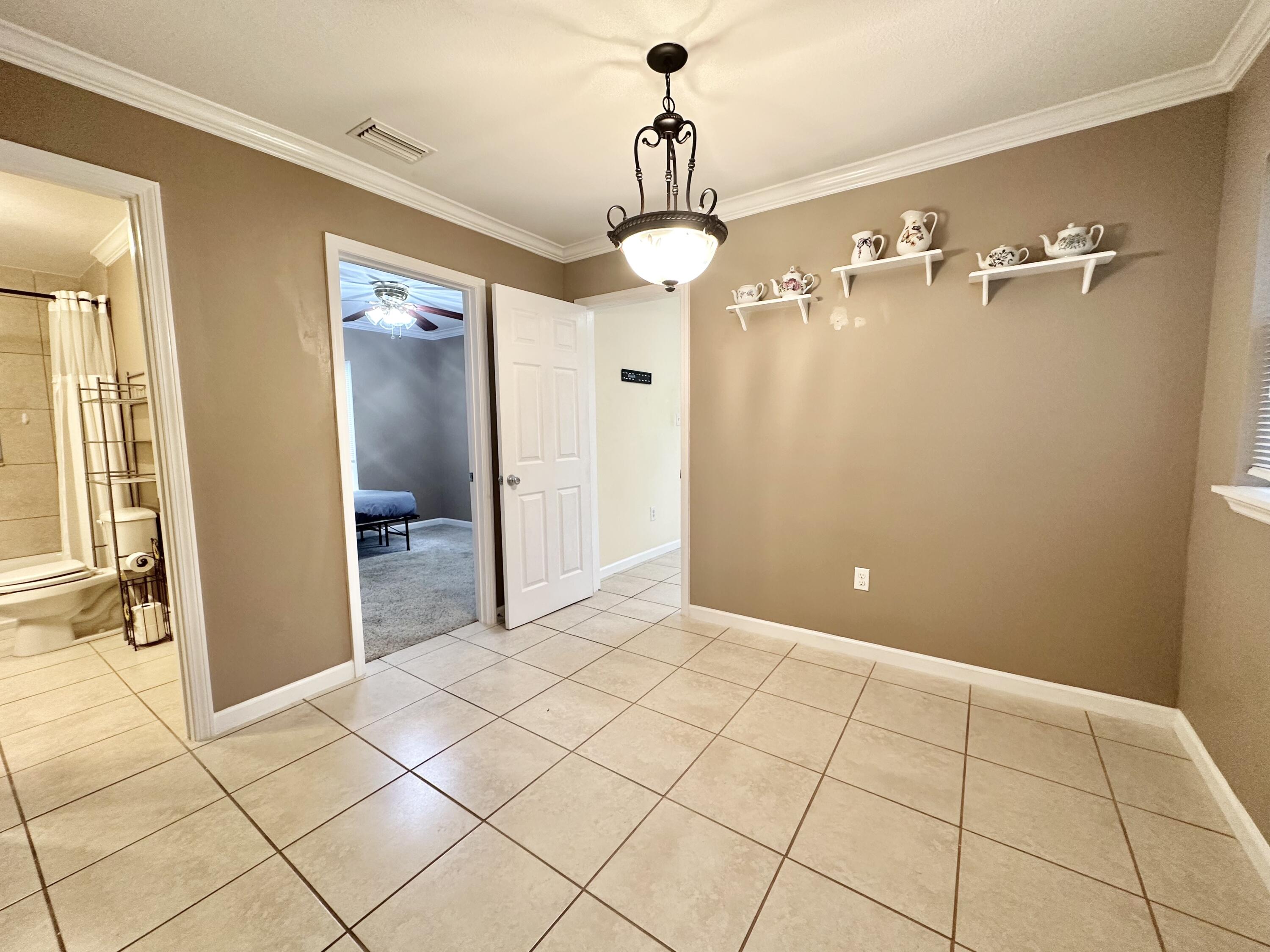 120 North Davis Lane DeFuniak Springs, FL 32433 - Photo 18 of 58 a view of a hallway with wooden floor