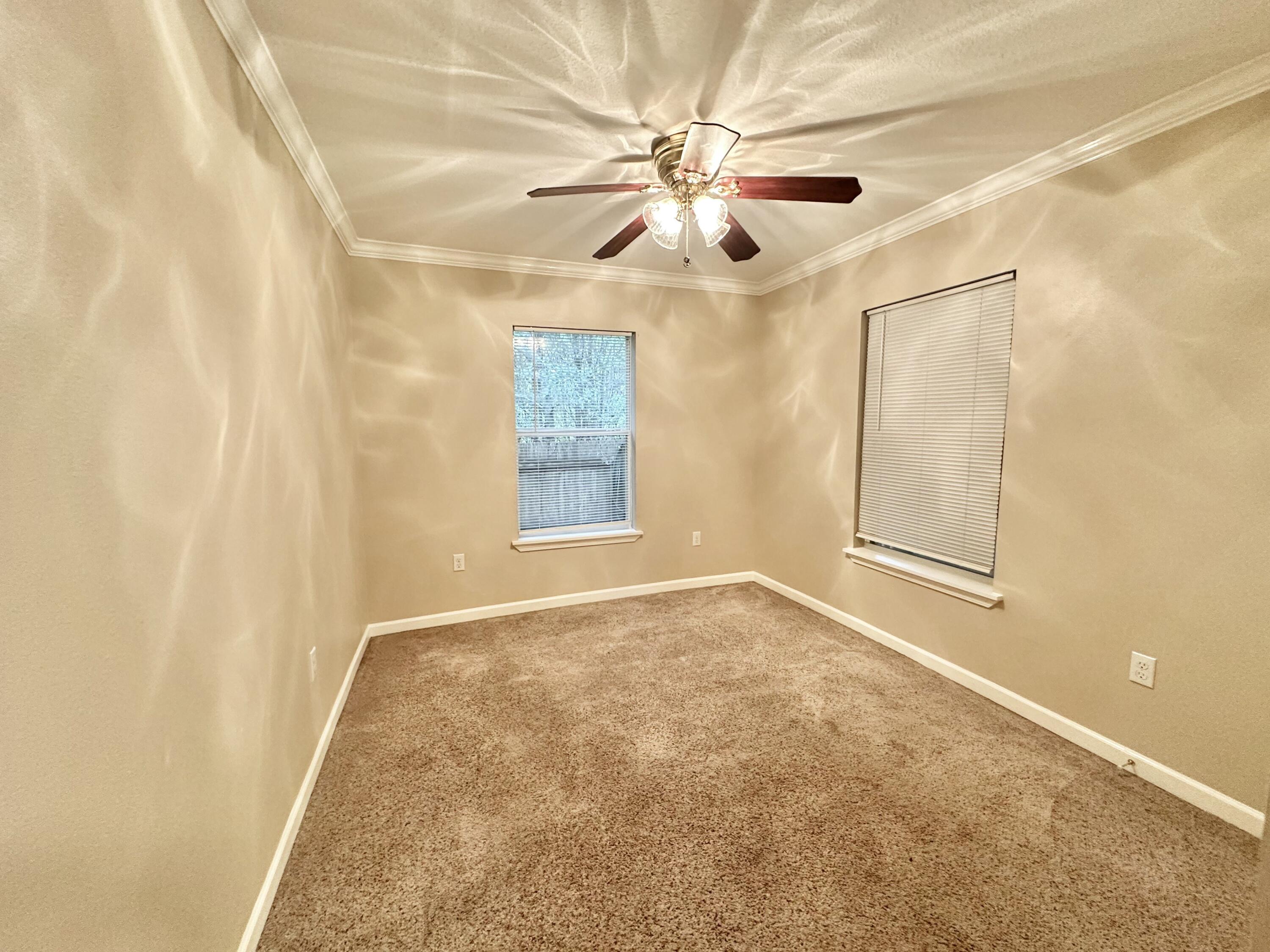 120 North Davis Lane DeFuniak Springs, FL 32433 - Photo 22 of 58 an empty room with windows and fan