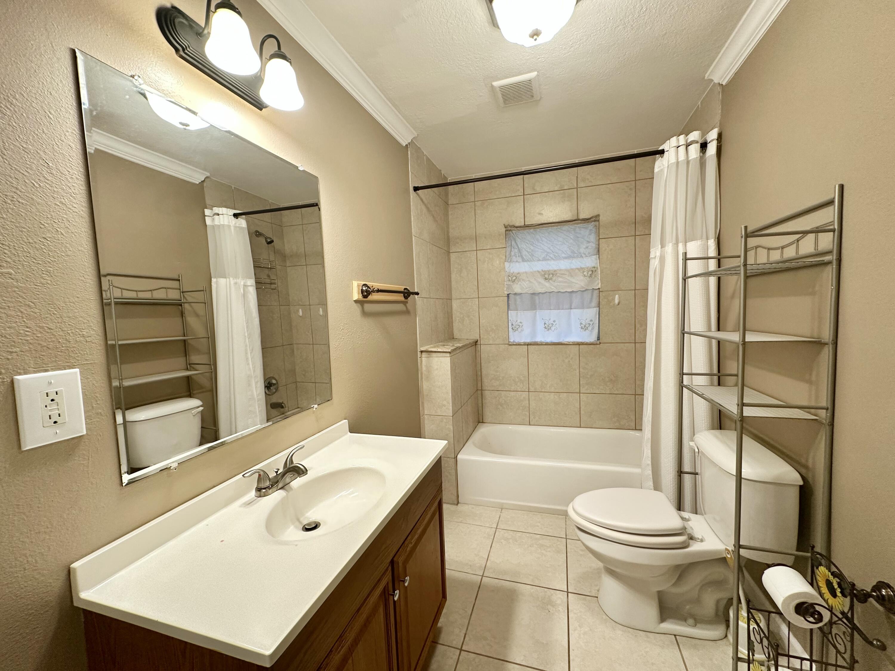 120 North Davis Lane DeFuniak Springs, FL 32433 - Photo 24 of 58 a bathroom with a sink toilet and shower