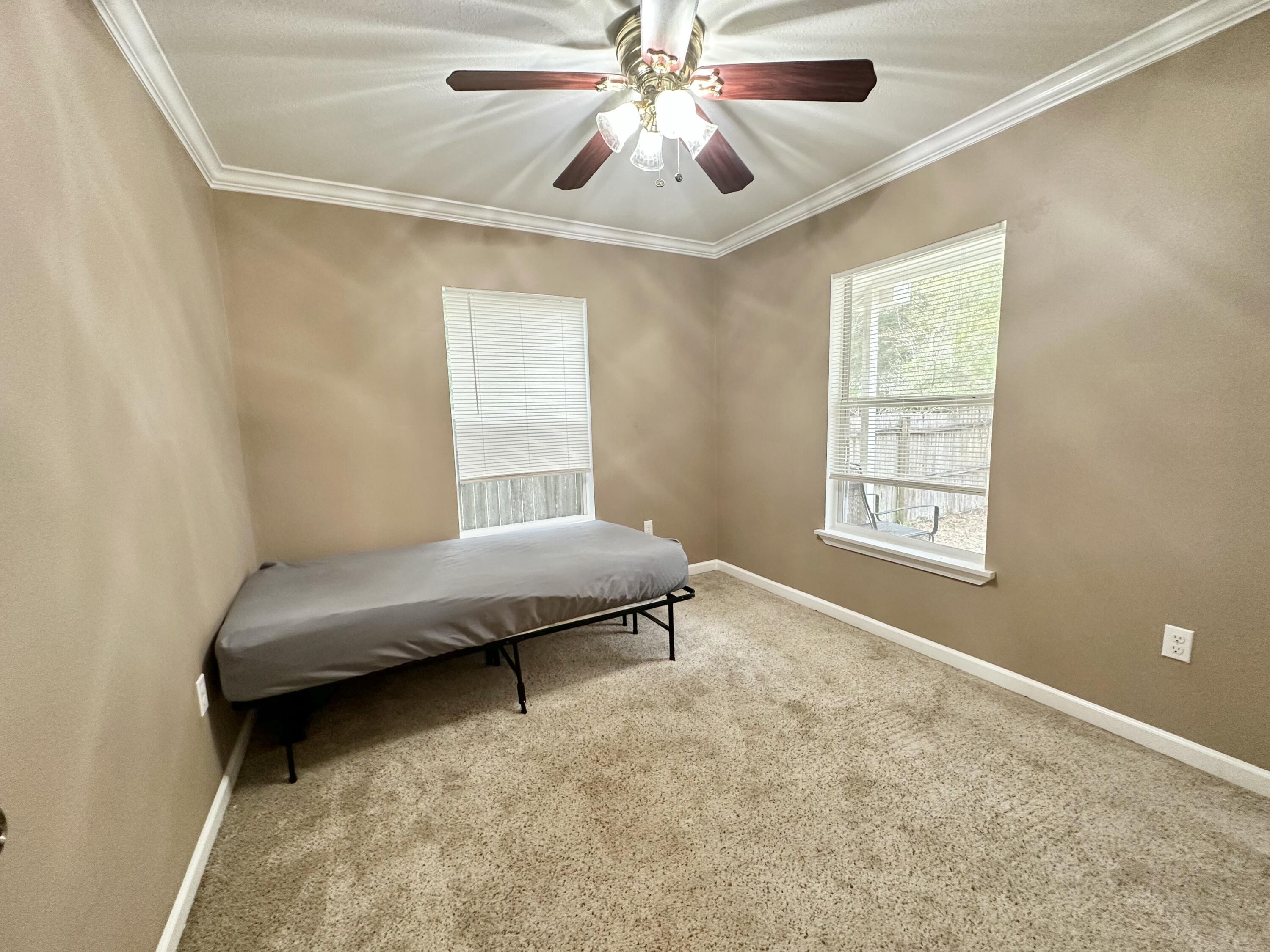 120 North Davis Lane DeFuniak Springs, FL 32433 - Photo 29 of 58 a bedroom with a bed and a chandelier