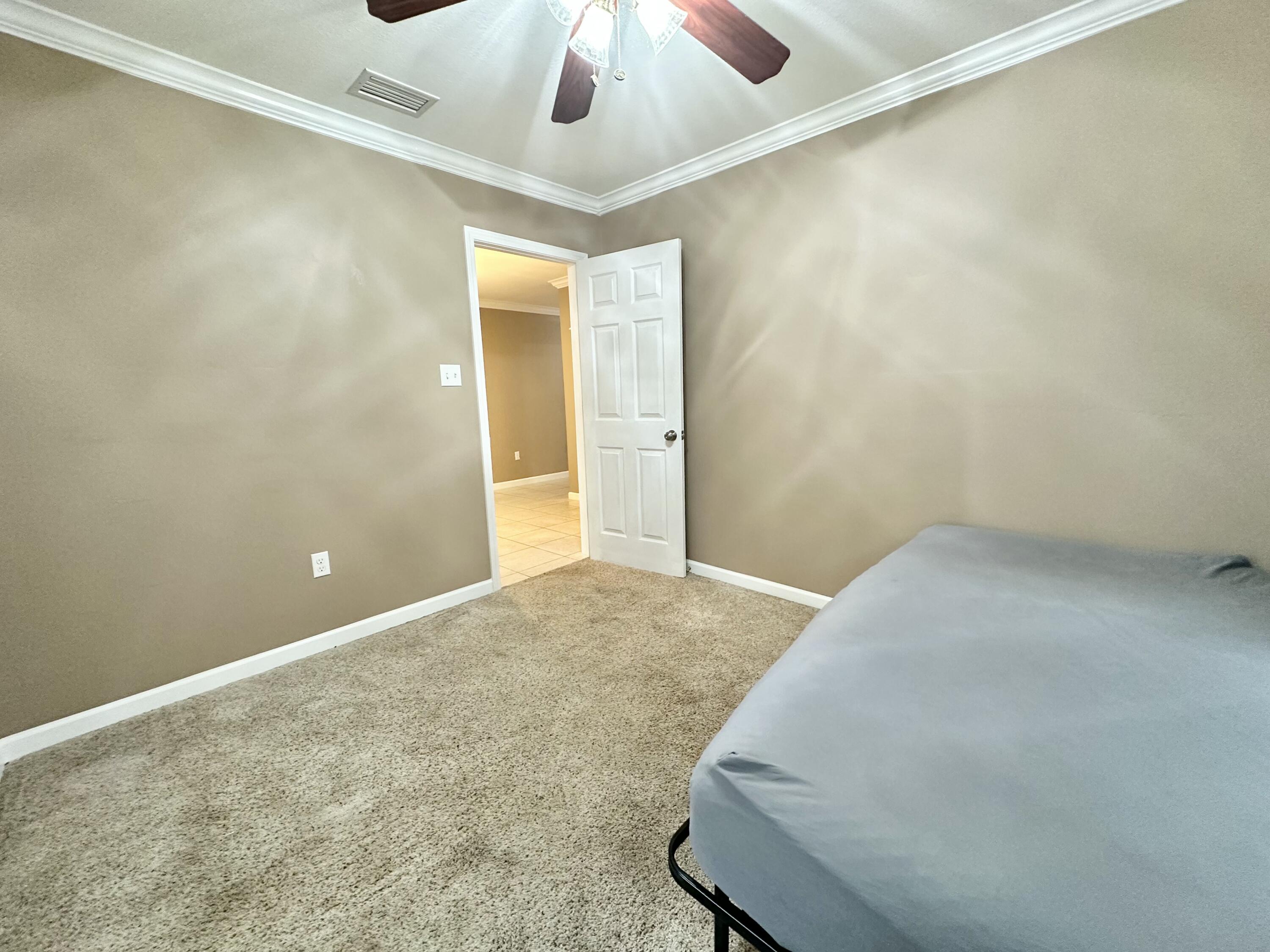 120 North Davis Lane DeFuniak Springs, FL 32433 - Photo 30 of 58 en empty room with a ceiling fan