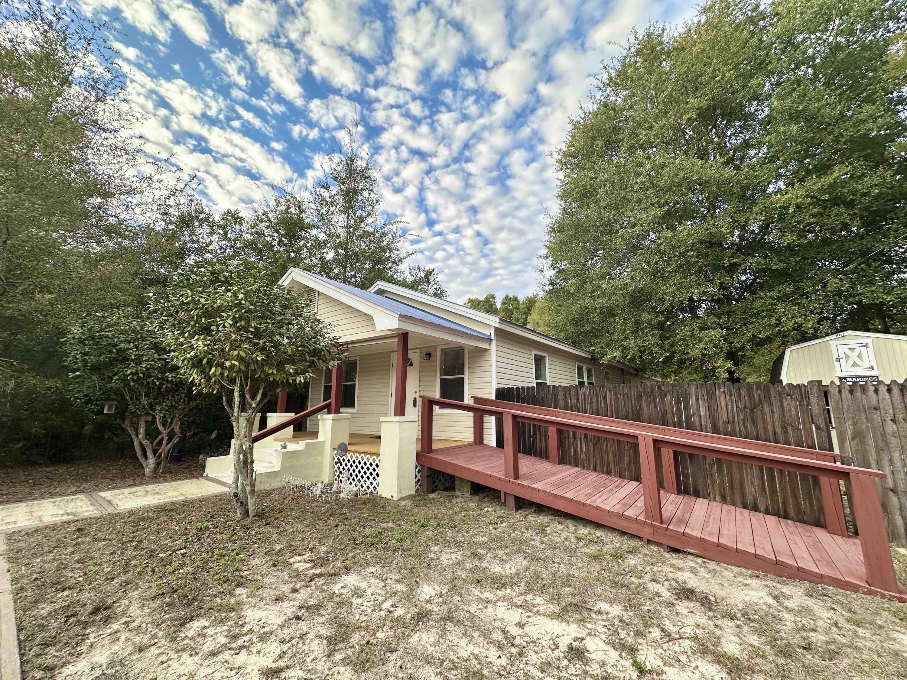 120 North Davis Lane DeFuniak Springs, FL 32433 - Photo 3 of 58 a view of a house with a backyard and a tree