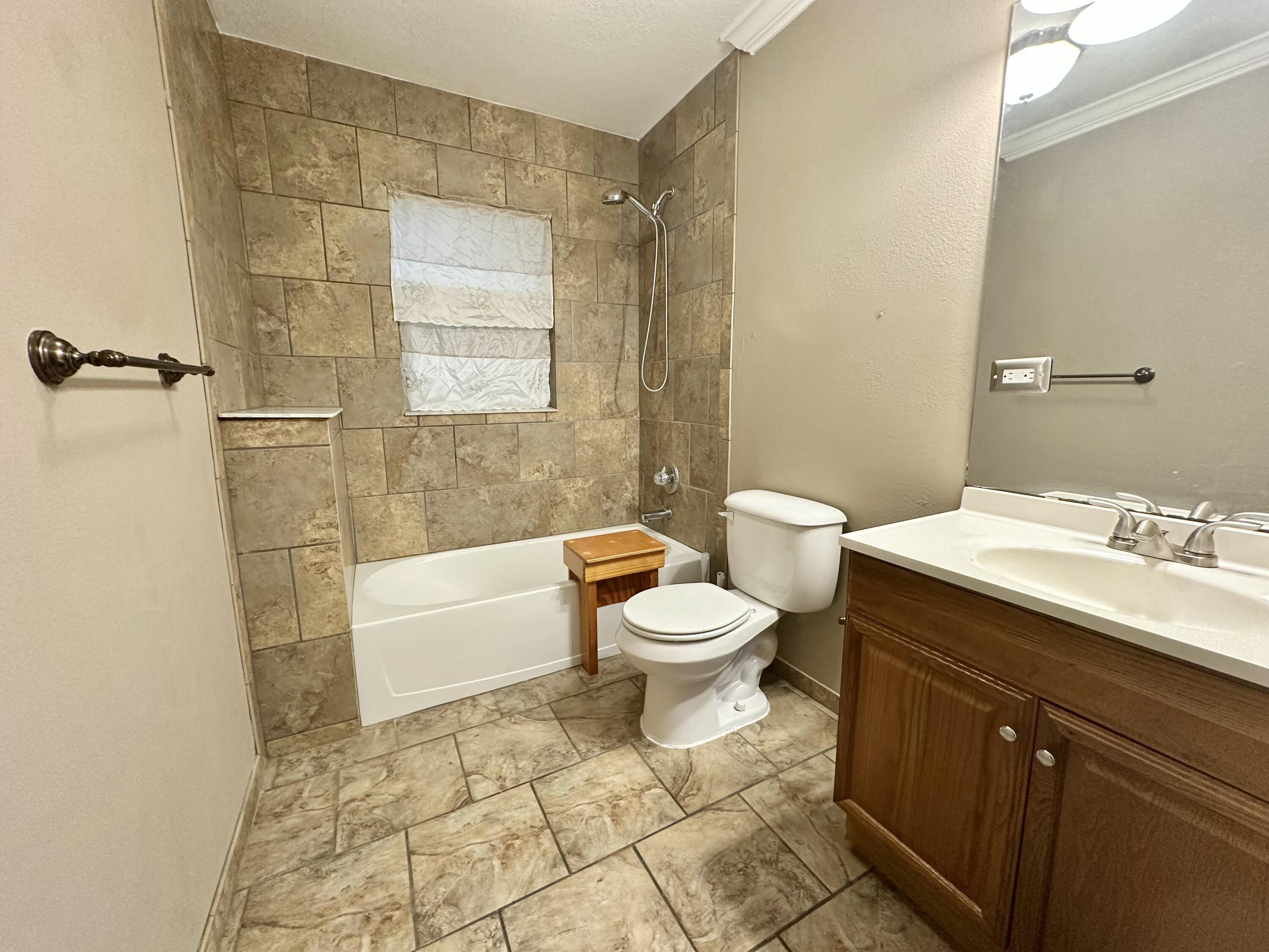 120 North Davis Lane DeFuniak Springs, FL 32433 - Photo 37 of 58 a bathroom with a sink a toilet and shower