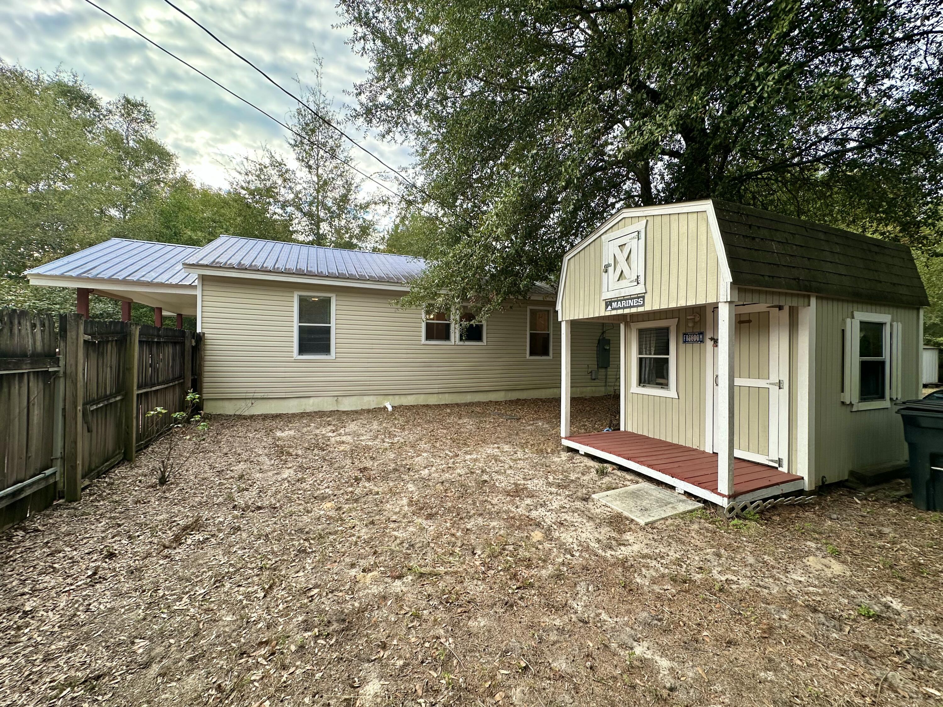 120 North Davis Lane DeFuniak Springs, FL 32433 - Photo 41 of 58 a front view of a house with a yard