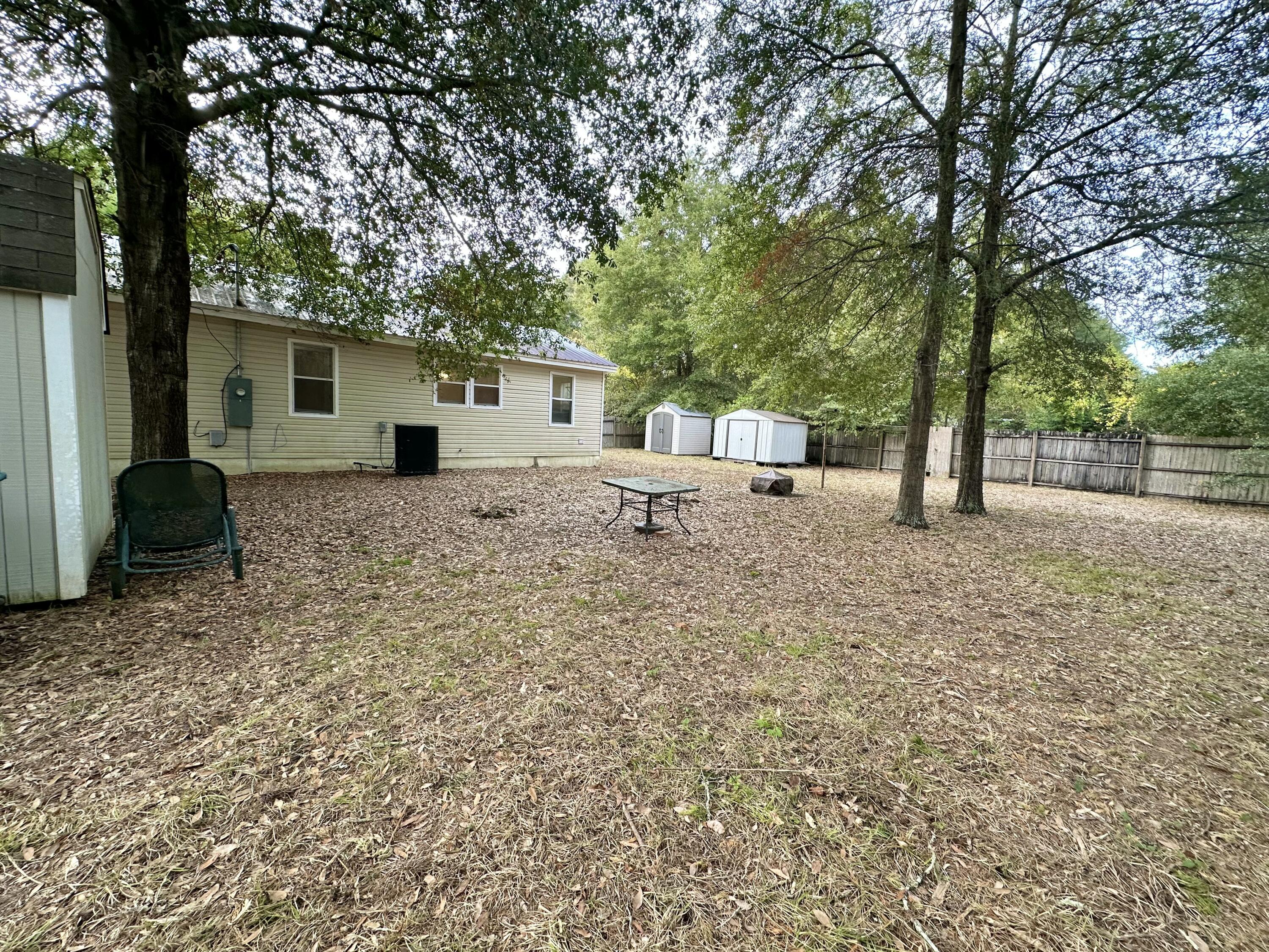 120 North Davis Lane DeFuniak Springs, FL 32433 - Photo 43 of 58 a backyard of a house with barbeque oven table and chairs