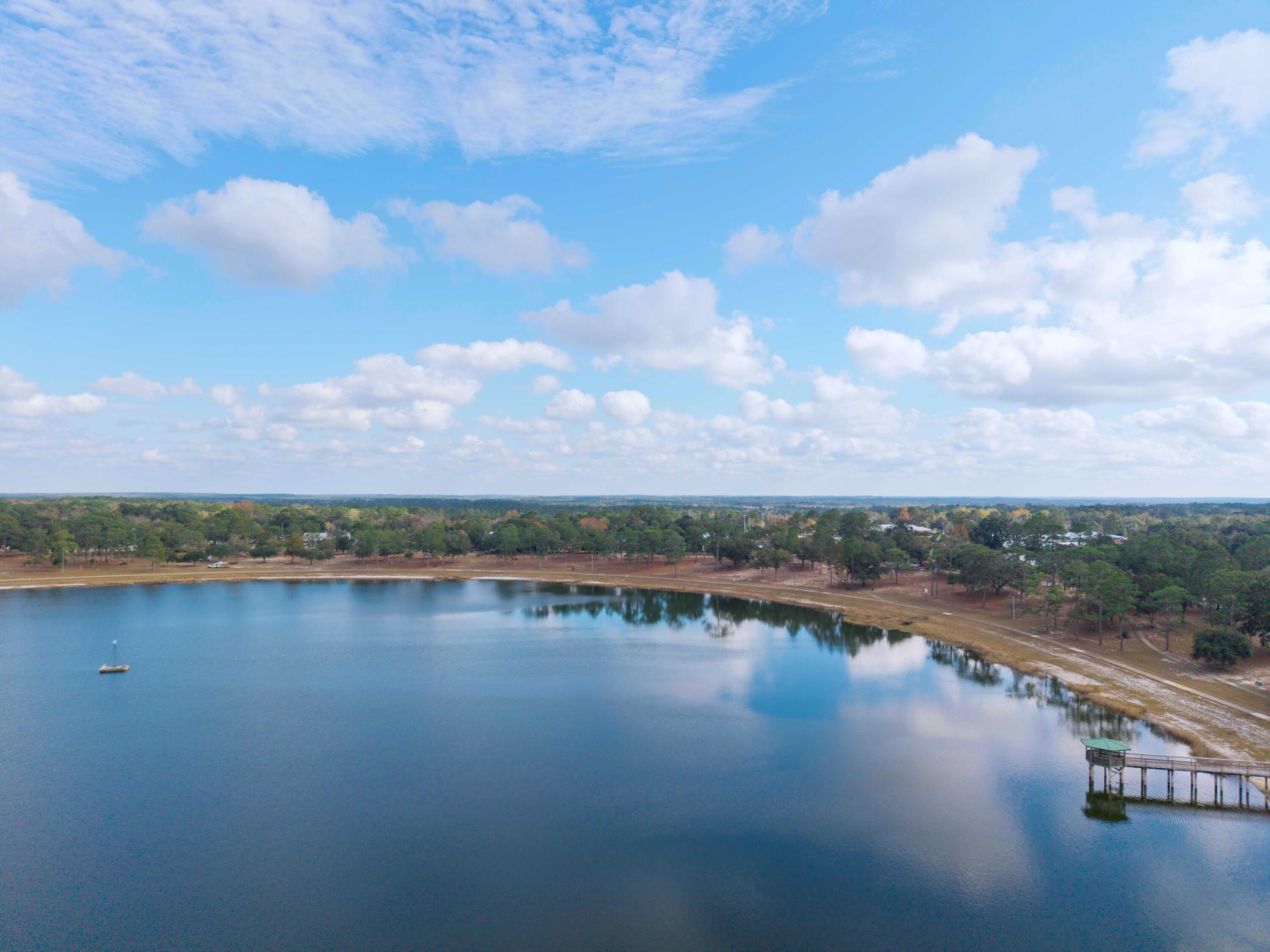 120 North Davis Lane DeFuniak Springs, FL 32433 - Photo 6 of 58 a view of a lake with houses in the back