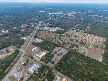 an aerial view of residential houses with outdoor space and street view