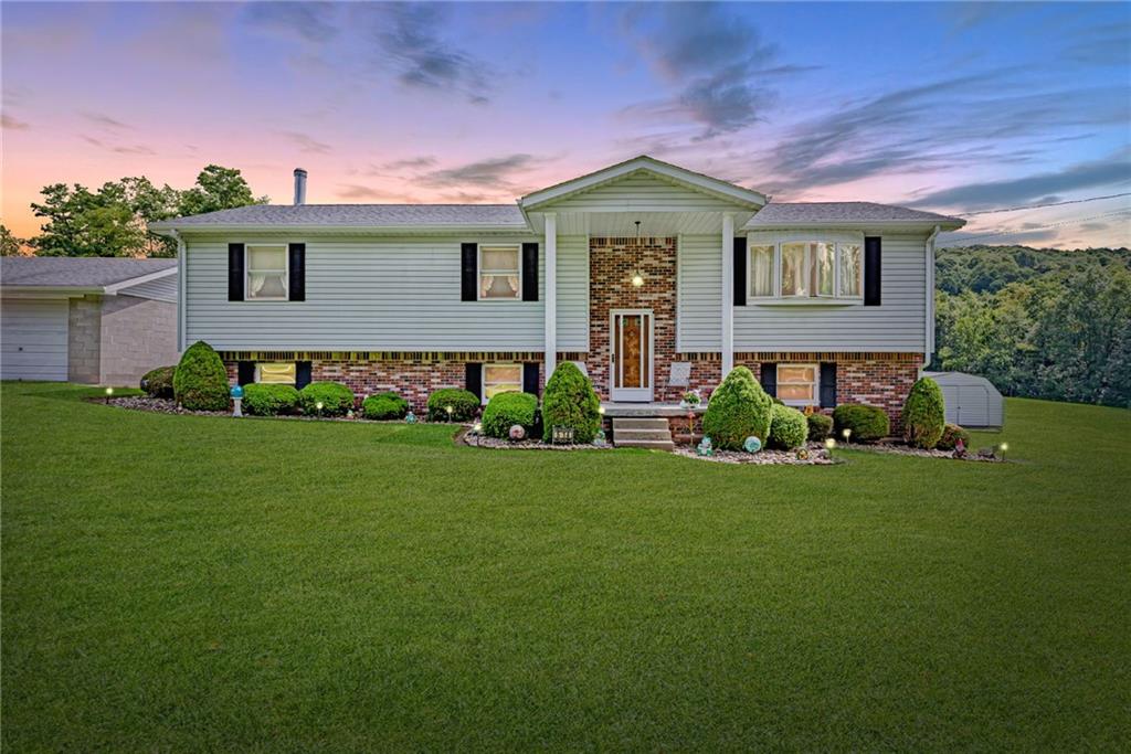 514 White Road Normalville, PA 15469 - Photo 1 of 32 a front view of a house with a garden
