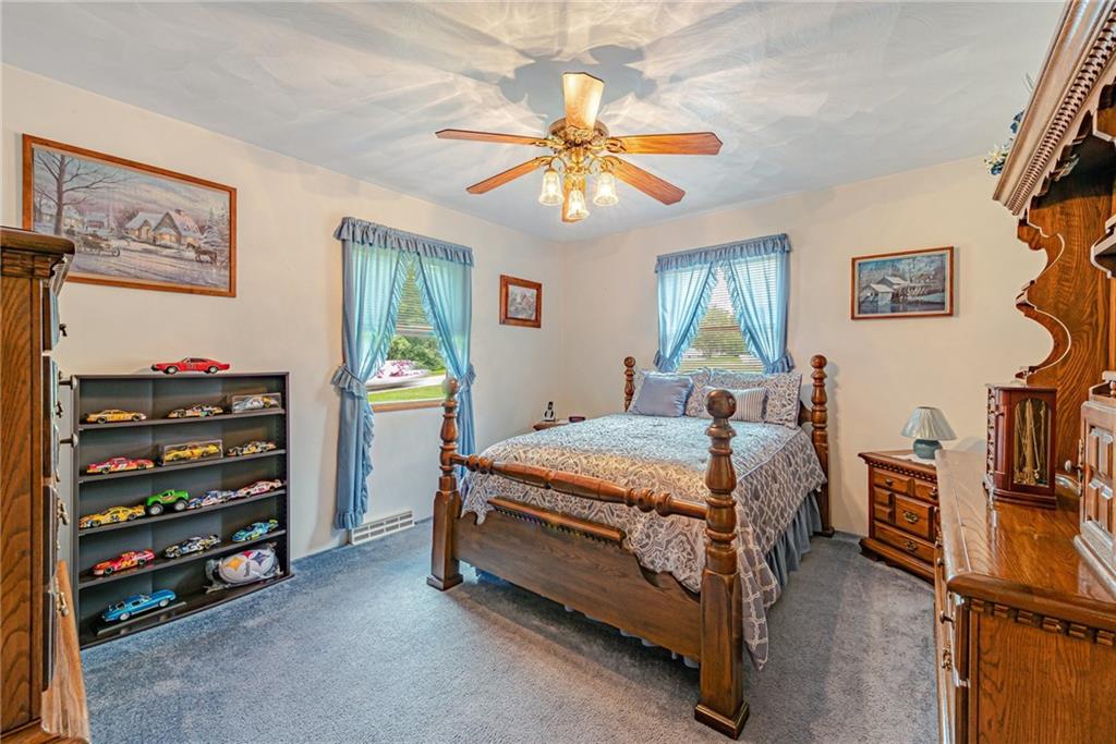514 White Road Normalville, PA 15469 - Photo 15 of 32 a bedroom with a bed closet and flat screen tv