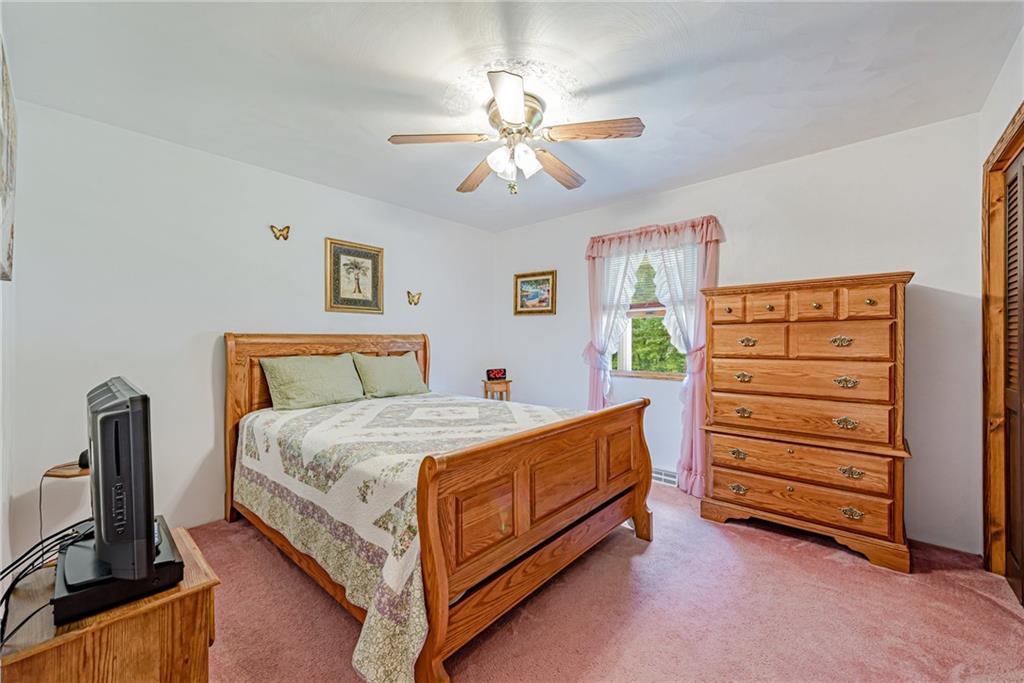 514 White Road Normalville, PA 15469 - Photo 18 of 32 a bedroom with a bed and a flat tv screen on the dresser
