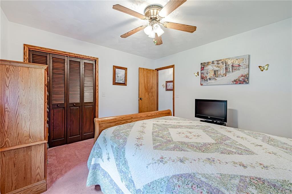 514 White Road Normalville, PA 15469 - Photo 19 of 32 a bedroom with a bed and a chandelier