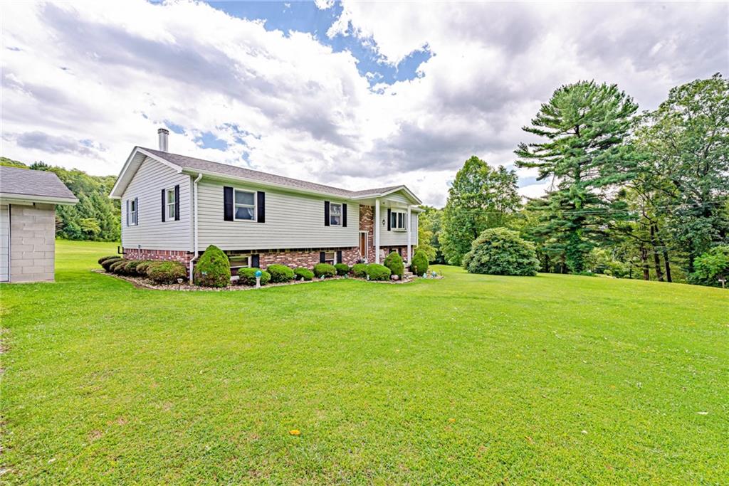 514 White Road Normalville, PA 15469 - Photo 2 of 32 a front view of a house with garden