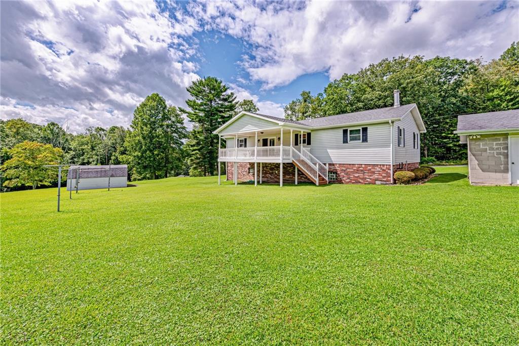 514 White Road Normalville, PA 15469 - Photo 26 of 32 a view of a house with a big yard and large trees