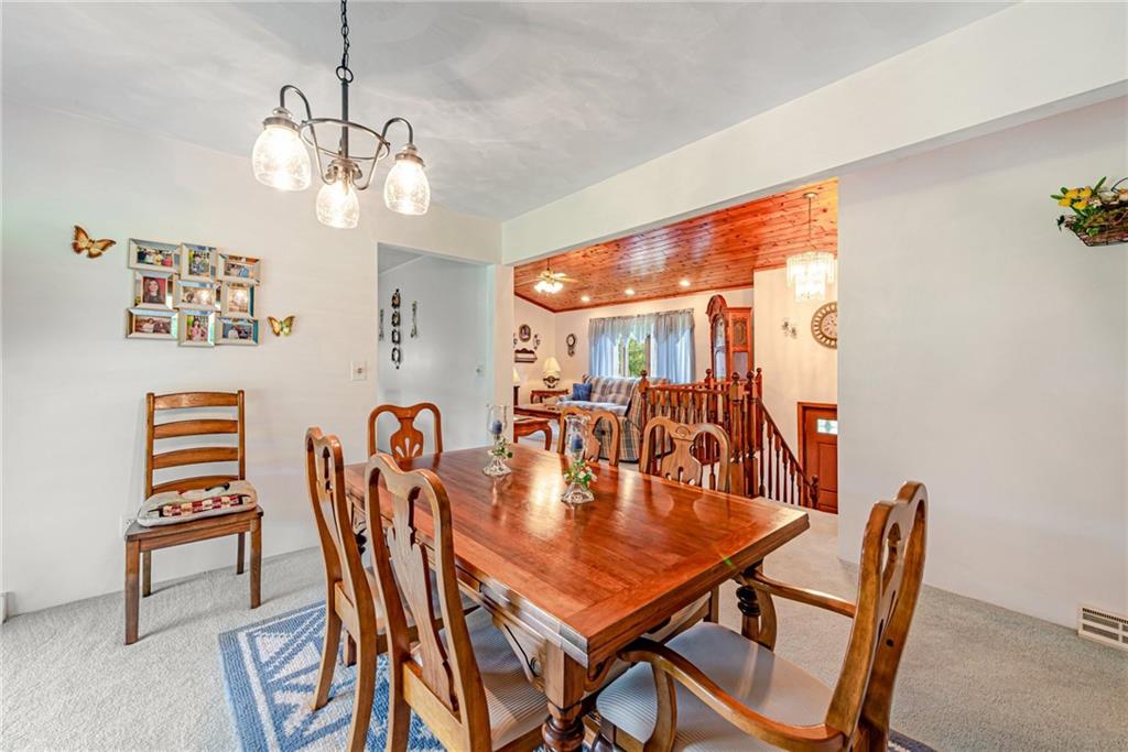 514 White Road Normalville, PA 15469 - Photo 6 of 32 a dining room with furniture a chandelier and wooden floor