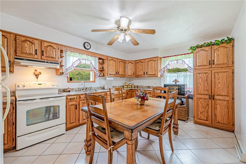 514 White Road Normalville, PA 15469 - Photo 9 of 32 a kitchen with a table chairs refrigerator and cabinets
